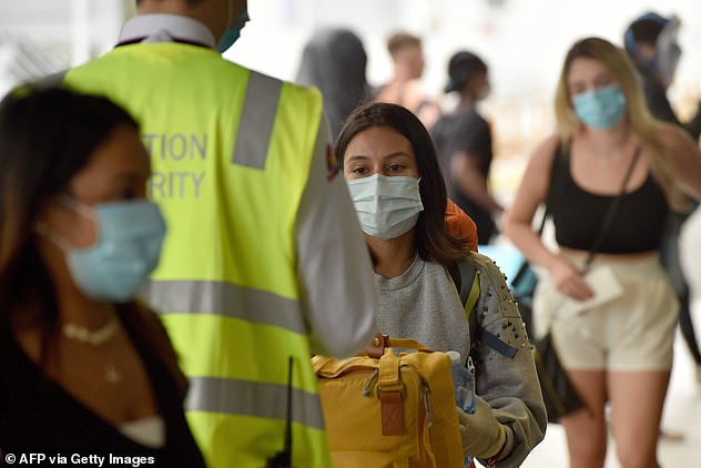 Immigration officials explained to the Sydney mother-of-one the damage meant the passport could have been tampered with (pictured, travellers queue up in the airport in April, 2020)