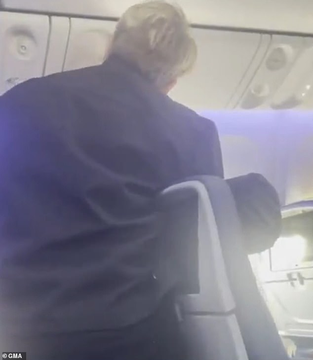 Airline staff were seen in the footage trying to calm down and restrain the stowaway, who reportedly tried to evade them at the start of the flight by walking from bathroom to bathroom