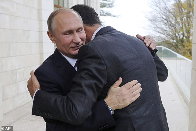 Putin embraces Assad during a meeting in 2017.  Russia has built up a massive military presence in Syria with an air base in Latakia and a naval facility in Tartus - which is Russia's only Mediterranean naval hub