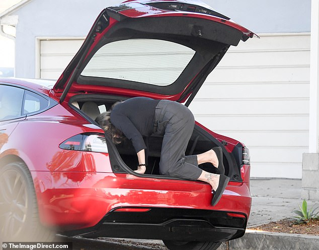 In this image she is seen completely climbed into her trunk