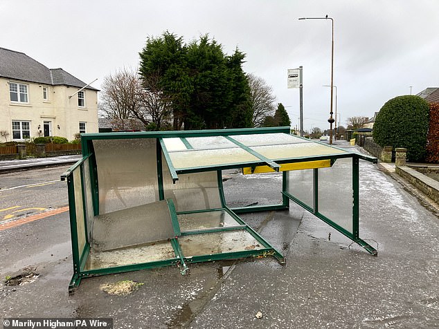 A bus shelter lies on its side and smashed up after the storm in Dechmont in West Lothian