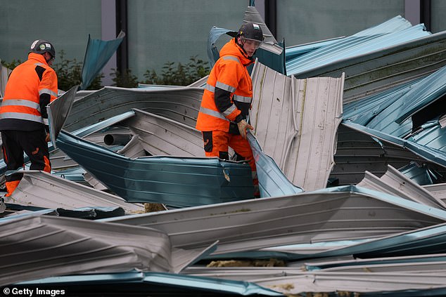 Scotland was issued with a rare red weather warning yesterday, with workers clearing the storm's debris