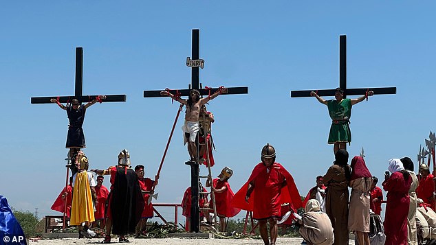 Three Filipino devotees hang on the cross as part of Good Friday rituals in the village of San Pedro Cutud, Pampanga province, northern Philippines, Friday, April 18, 2025