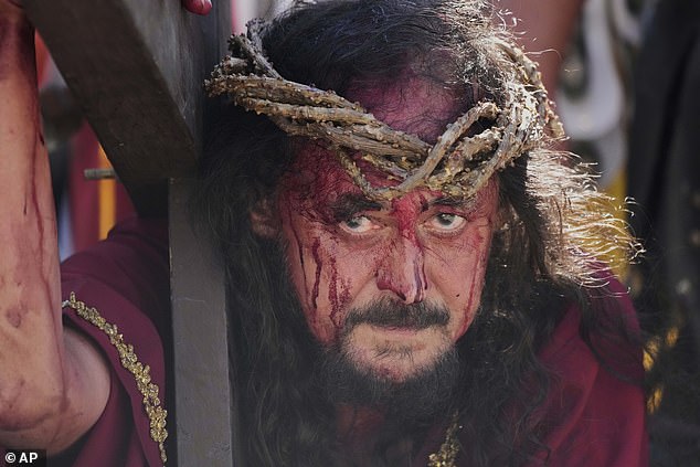 A performer reenacts the crucifixion of Jesus Christ to mark Maundy Thursday in Paete town, Laguna province, Philippines, April 17, 2025