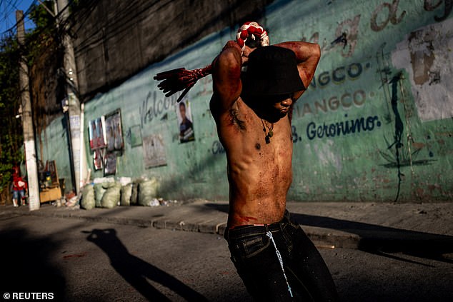 A penitent performs self-flagellation on Good Friday in Navotas City, Metro Manila, Philippines, April 18, 2025