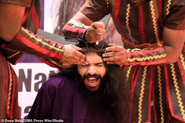 Christian devotees re-enact the crucifixion of Jesus Christ during a Good Friday procession at Kalina in Mumbai, India