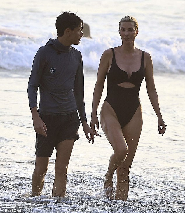 Later on in the day, Ivanka switched into a black one-piece so she could get into the water and catch some waves
