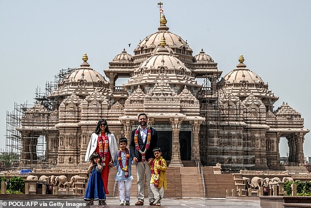 US Vice President JD Vance (2R) and his wife Usha Vance (2L), along with their children Ewan (C), Vivek (R) and Mirabel, pose for a photo in front of the Akshardham Temple in New Delhi