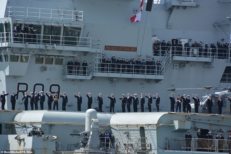 Excited sailors on the aircraft carrier all lined the deck as it departed Portsmouth - dubbed the home of the Royal Navy
