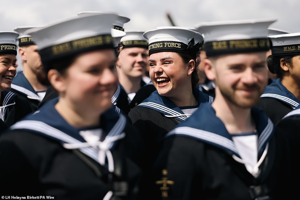 Sailors were all smiles as they lined up on the aircraft carrier's vast four-acre flight deck to wave goodbye to loved ones