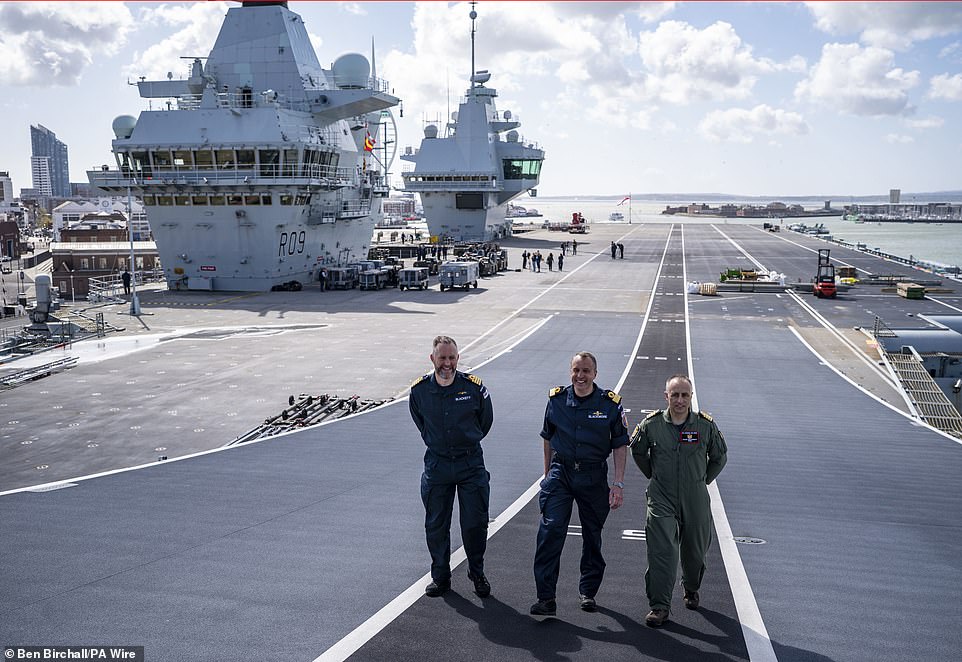 Captain Will Blackett RN, commanding officer of HMS Prince of Wales, left, Commodore James Blackmore RN, commander Carrier Strike Group, centre, and Captain Colin McGannity RN, commander Air Group, right, onboard HMS Prince of Wales