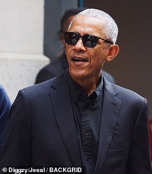 Obama was pictured in a sleek black suite on the streets of NYC