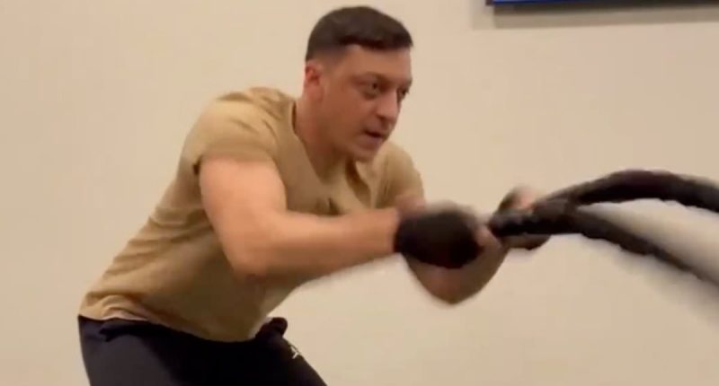 Cristiano Ronaldo applauds Mesut Ozil for his rigorous gym workout... as the former Arsenal midfielder shows off his muscular physique - just a year on from his retirment