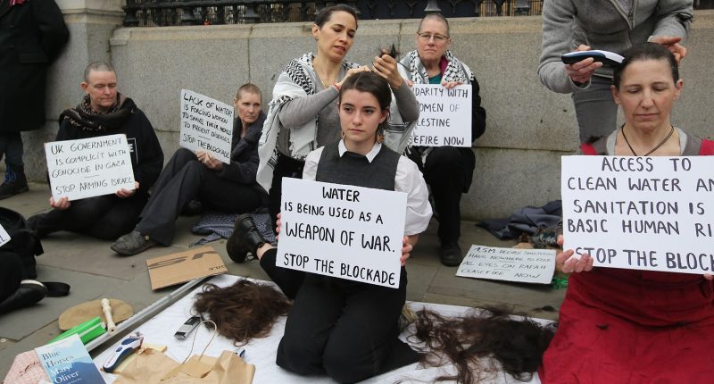 Women shave their heads in Gaza protest outside UK parliament | Gaza