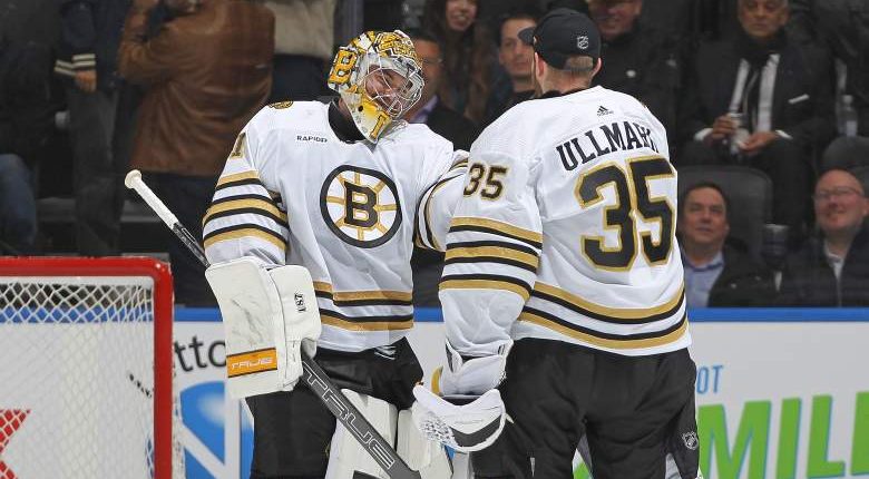 Jeremy Swayman of the Boston Bruins celebrates a victory with teammate Linus Ullmark