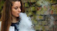 Top doctor Kerry Chant has declared a war on illegal vapes with more than $1million worth of e-cigarettes and liquids seized this year (pictured, a woman smoking an electric cigarette)