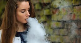 Top doctor Kerry Chant has declared a war on illegal vapes with more than $1million worth of e-cigarettes and liquids seized this year (pictured, a woman smoking an electric cigarette)