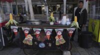 A street vendor displays corn cobs on his cart at Manger Square, adjacent to the Church of the Nativity, traditionally recognized by Christians to be the birthplace of Jesus Christ, on Christmas Day in the West Bank city of Bethlehem Tuesday, Dec. 24, 2024. (AP Photo/Nasser Nasser)