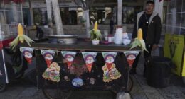 A street vendor displays corn cobs on his cart at Manger Square, adjacent to the Church of the Nativity, traditionally recognized by Christians to be the birthplace of Jesus Christ, on Christmas Day in the West Bank city of Bethlehem Tuesday, Dec. 24, 2024. (AP Photo/Nasser Nasser)