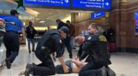 Dramatic moment armed vigilante is arrested at Phoenix Airport after shooting that left several injured