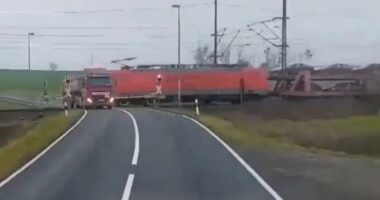 Dramatic moment freight train smashes into stranded truck at level-crossing SECONDS before driver escaped vehicle