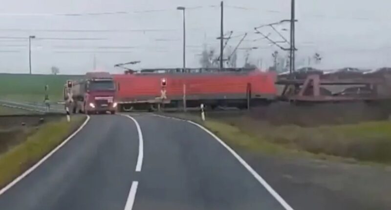 Dramatic moment freight train smashes into stranded truck at level-crossing SECONDS before driver escaped vehicle