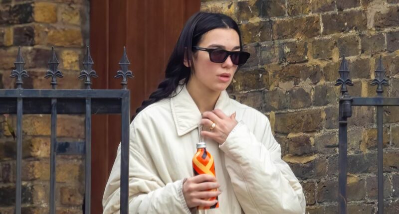 Dua Lipa flashes huge engagement ring after Callum Turner's romantic proposal as she goes makeup free for hot yoga session