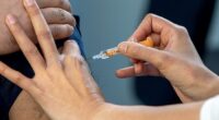 The flu vaccine given to millions may be much less effective than expected as a pre-Christmas outbreak sweeps Britain