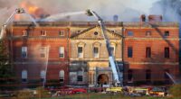 Grand plans to spend £63million on maintaining the fire-wrecked look for a Grade I listed mansion rather than restoring a 'great jewel of British architecture' is blasted as an 'act of barbarianism'