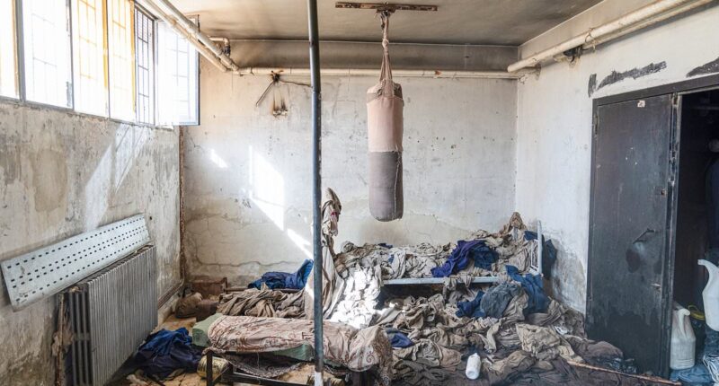 Inside Syria's 'human slaughterhouse' execution block: Chilling images show punch bag used by guards to practice torturing prisoners and scattered possessions left behind