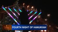 Menorah lighting held by Rabbi Baruch Hertz, Chabad of West Lakeview in Lincoln Square to mark 4th night of Hanukkah