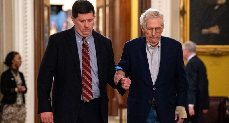 Mitch McConnell clings onto aide as he walks into Senate with injuries to his face and wrist after scary fall