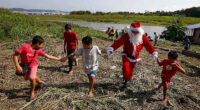 Santa braves the sticky heat of the Amazon jungle to bring gifts to children in Brazilian village