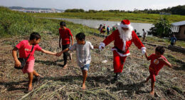 Santa braves the sticky heat of the Amazon jungle to bring gifts to children in Brazilian village