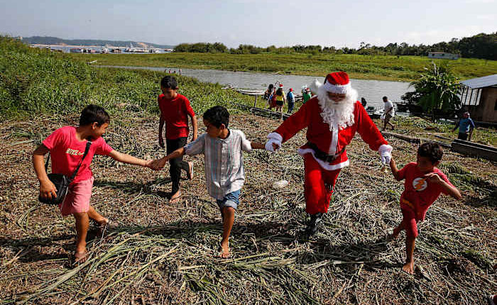 Santa braves the sticky heat of the Amazon jungle to bring gifts to children in Brazilian village