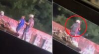 Shocking moment police officer throws delivery worker off BRIDGE in Brazil during traffic stop