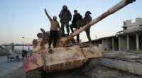 Syrian rebels 'take control of Aleppo' as Bashir al-Assad's forces collapse almost overnight while leader is out of the country