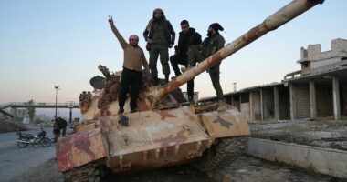 Syrian rebels 'take control of Aleppo' as Bashir al-Assad's forces collapse almost overnight while leader is out of the country