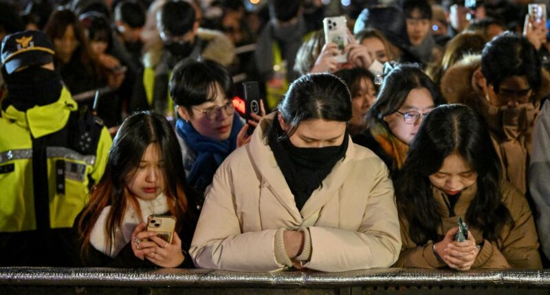 Watch haunting moment mourning South Korea marks New Year with SILENT crowds after plane disaster and ‘coup’ drama