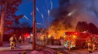 Watch terrifying moment barrage of fireworks launch from huge house blaze as firefighters battle inferno