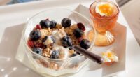 bowl of yogurt with berries and granola with an egg