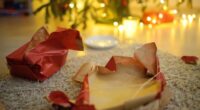 Empty gift wrapping under the tree on Christmas morning. A plate of cookie crumbs and an empty milk glass after a night visit from Santa Claus. Santa delivered gifts under the Christmas tree.