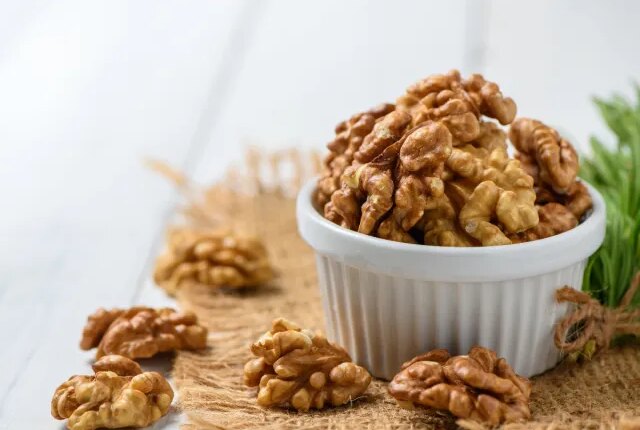 walnuts in bowl, concept of best nuts for weight loss