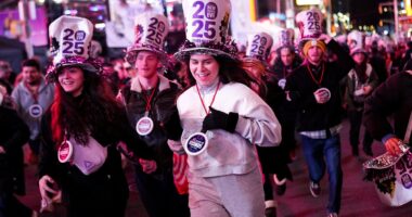 America ends 2024 in style! Thousands descend on Times Square to welcome in the New Year (despite fears of a washout)