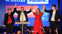 Anthony Albanese (pictured with Penny Wong, girlfriend Jodie and son Nathan) has declared 'Aussies have voted for change' after securing a historic election win - and also blasted rowdy supporters in his victory speech