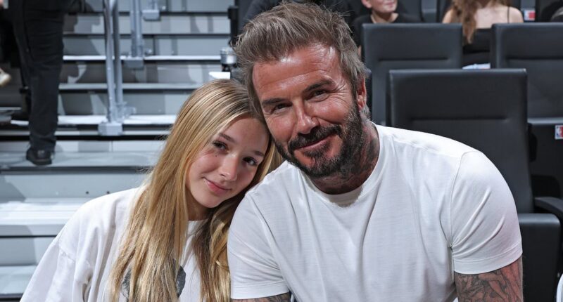 David Beckham poses with daughter Harper for sweet snap as they kick off the New Year at a basketball game in Miami