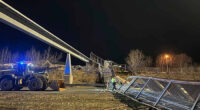 Fencing, roof of Anchorage pedestrian bridge fall in strong wind, closing highway