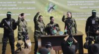 Israeli female soldier hostages wave at a Palestinian crowd