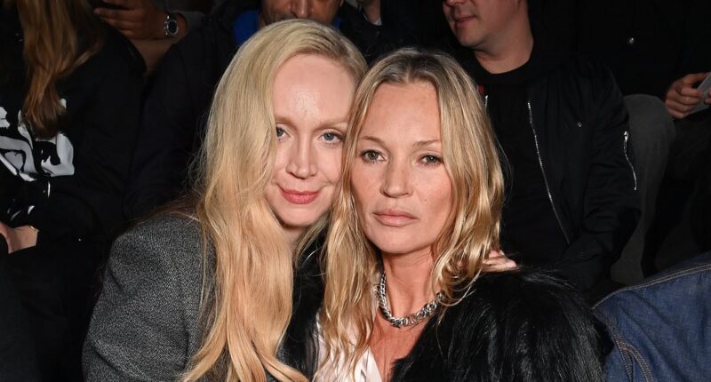 Kate Moss kisses glam pal Gwendoline Christie on the cheek and she puts on an animated display on the FROW with Miles Chamley-Watson at Dior Homme show for Paris Fashion Week