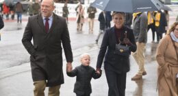 Lucas Tindall, 3, delights with his cheeky antics as he joins parents Mike and Zara at New Year's Day meeting at Cheltenham Racecourse